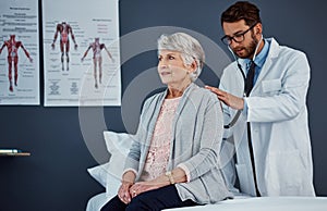 Its essential to have regular checkups with the doctor. a doctor examining a senior patient with a stethoscope in a