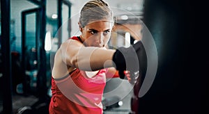 Its about the follow-through. Cropped shot of an attractive young female kickboxer working out in the gym.