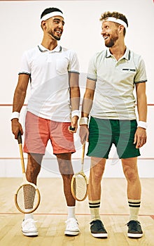 Its game time. two young men getting ready to play a game of squash.