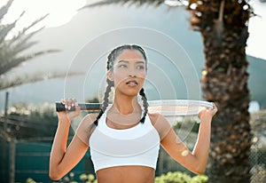Its a good day to win. a sporty young woman playing tennis on a court.