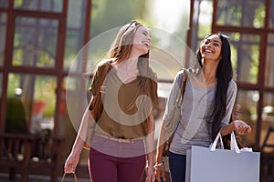 Its a great day for shopping. Two attractive young woman with their shopping bags after a day of retail therapy.