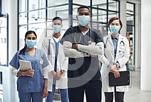 Its important to keep yourself protected. Shot of a group of doctors and nurses wearing face masks to protect from