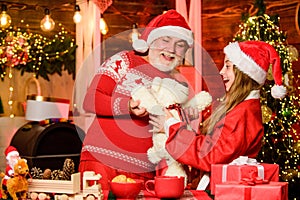 its lovely. father and daughter love christmas. grandfather and grandchild at home. xmas happiness and joy. gift for