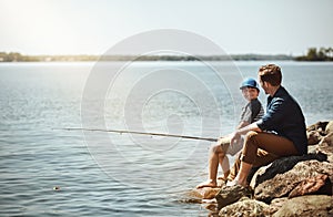 Its so much fun fishing with you, Dad. a father and his little son fishing together.