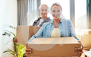 Its never too late to buy your dream home. Portrait of a happy mature couple carrying boxes on moving day.