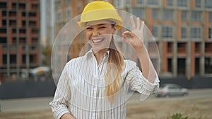 Its OK! confident joyful woman architect in a hard hat looks at the camera and shows a gesture ok. 4K