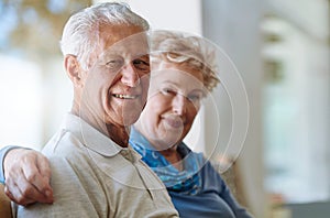 Its our time to unwind. Portrait of a senior couple relaxing together on the sofa at home.