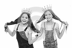 Its pride that drives them. Adorable little princesses in crowns with long hair source of their pride. Cute small girls