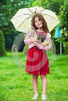 Its rainy weather. small girl hold kitten. kid love her pet. human and animals. love and care. fluffy cat in hand of