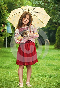 its rainy weather. small girl hold kitten. kid love her pet. human and animals. love and care. fluffy cat in hand of