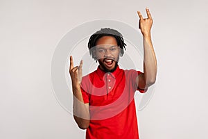 Its rock n roll baby! Portrait of bearded man with dreadlocks wearing red casual style T-shirt, looking at camera with rock sing