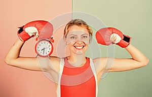 Its time for boxing training. happy woman boxing gloves. girl boxer hold alarm clock. morning energy. full of power