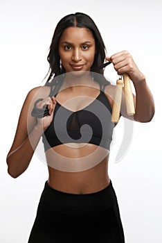 Its time for a cardio session. Studio portrait of a sporty young woman posing with a skipping rope around her neck