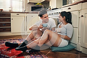 Its time for coffee and catchup. a young couple having coffee in their kitchen at home.