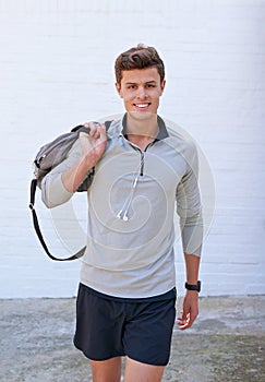 Its time for my gym session. a handsome young man holding his gym bag, ready for a workout.