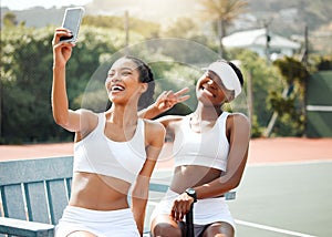 Its a whole different feeling to be on the court. two sporty young women taking selfies together on a tennis court.