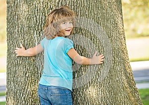 Its so wide. Boy child try to climb tree. Childhood and boyhood. Boyhood days. Tree climbing