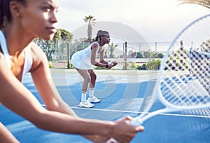 Its the will to prepare to win that matters. two attractive young women standing together while playing tennis.