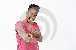 Its you, congratulations. Smiling african american man pointing fingers at camera, laughing and grinning, choosing