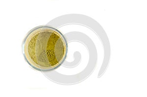 Green tea powder in a glass isolated on white background photo