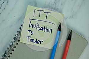 ITT - Invitation To Lender write on sticky note isolated on Wooden Table