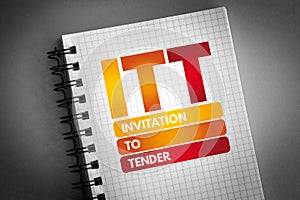 ITT - Invitation To Tender acronym on notepad, business concept background