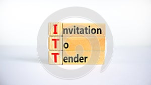 ITT invitation to tender symbol. Concept words ITT invitation to tender on blocks on a beautiful white table, white background.