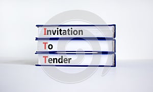 ITT invitation to tender symbol. Concept words ITT invitation to tender on books on a beautiful white table, white background.