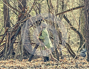 Ittle cute girl builds a hut in the woods