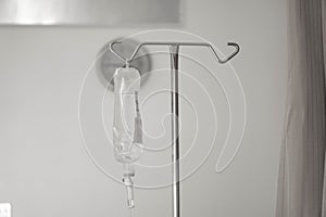 IV bag hanging on a metal pole in the hospital room