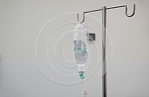 IV bag hanging on a metal pole in the hospital room