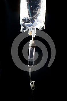 IV Bag With IV Tubing On Dark Background