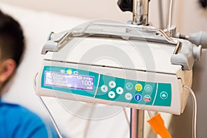 IV infusion pump regulator with patient at background