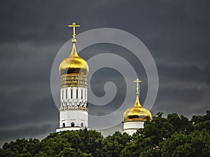 Ivan the Great bell tower in Moscow. Golden domes of the old Cathedral in the Moscow Kremlin before a downpour