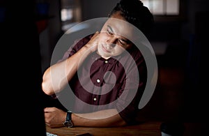 Ive been sitting here for quite some time now. a young businessman experiencing neck pain while working on a computer in