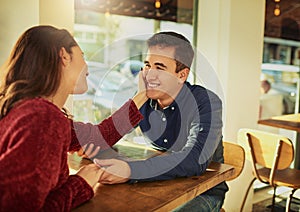 Ive only got eyes for you. a young man and woman on a romantic date at a coffee shop.