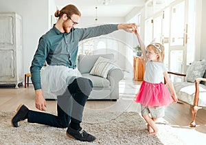 Ive got a little poser. Full length shot of an adorable little girl wearing a tutu and dancing with her father in the