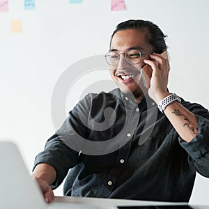 Ive got success on the line. a handsome young businessman making a phone call while working in his office.