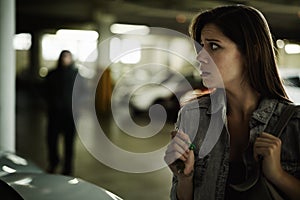 Ive got to get away from here. A terrified young woman in an underground parking garage being followed by a sinister man