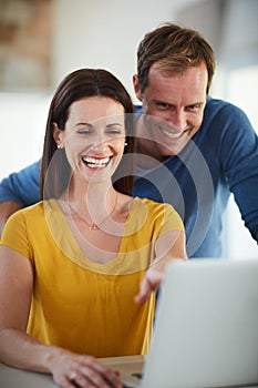 Ive got to show you this hilarious video online. Cropped shot of a mature couple using a laptop together at home.