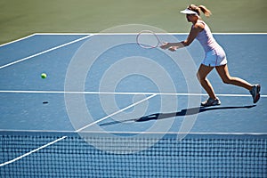 Ive got it. Young woman playing tennis on the court.