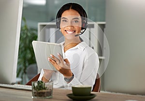 Ive got your query covered. a young woman using a headset and digital tablet in a modern office.