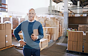 Ive got your shipment ready for transport. Portrait of a mature man standing in a distribution warehouse.