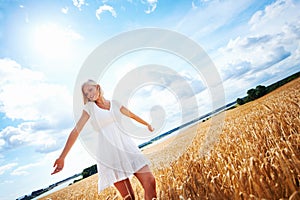 Ive never felt more free. Happy young woman walking through a wheat field.