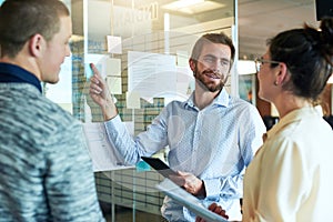 Ive worked in out and this is our best option. a group of businesspeople brainstorming with notes on a glass wall in an