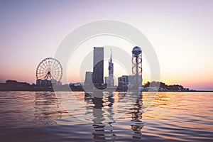 Iveria beach waterfront view with famous Batumi landmarks in the background: Chacha tower Ferris wheel and alphabetic tower. photo