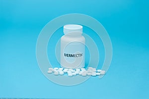IVERMECTIN in white bottle packaging with scattered pills