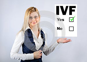 IVF. A woman holds a questionnaire where they chose in vitro fertilization photo