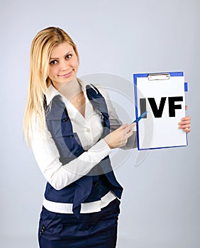 IVF. A woman shows on her tablet the abbreviation in vitro fertilization photo