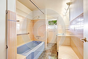 Ivory bathroom with blue bath tub